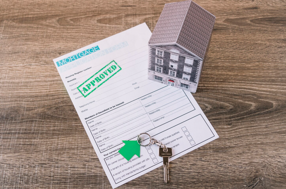 Mortgage approval form with house keys symbolizing property ownership deed