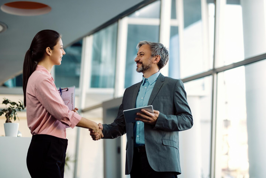 Employee shaking hands with manager after successfully negotiating severance package