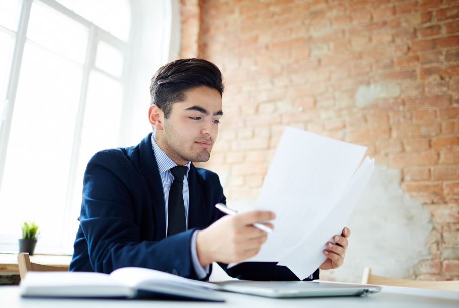Entrepreneur reviewing business documents to decide whether to form an LLC business