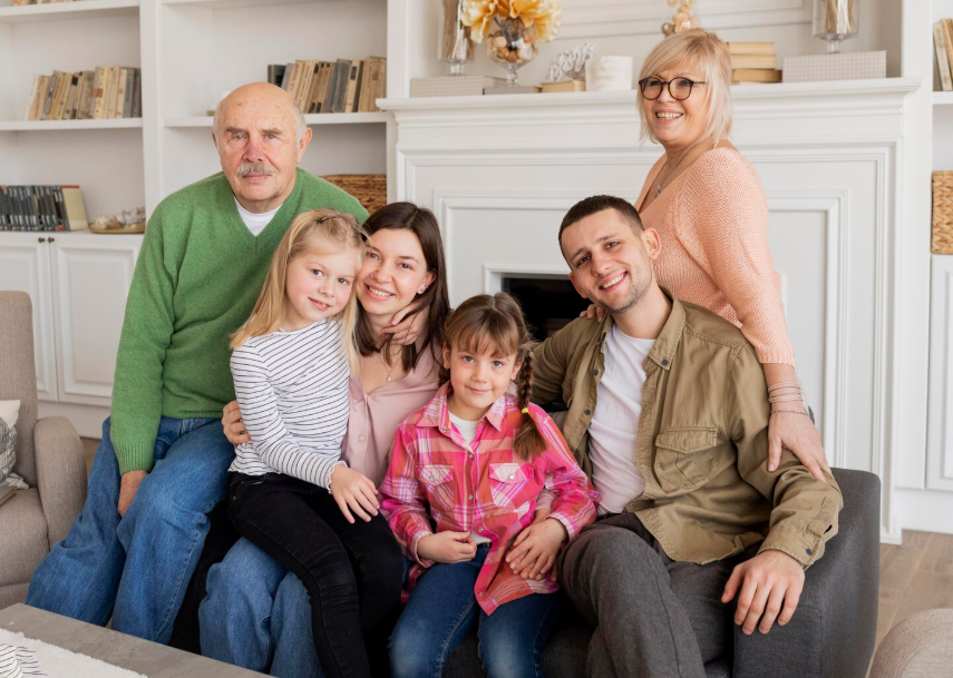 Blended family of multiple generations smiling together at home, symbolizing unity and thoughtful estate planning